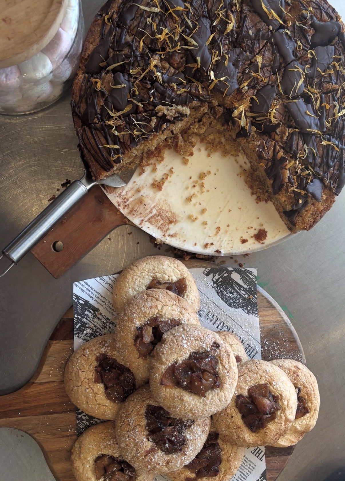 Chocolate caramel tart and apple-filled cookies on the cafe counter